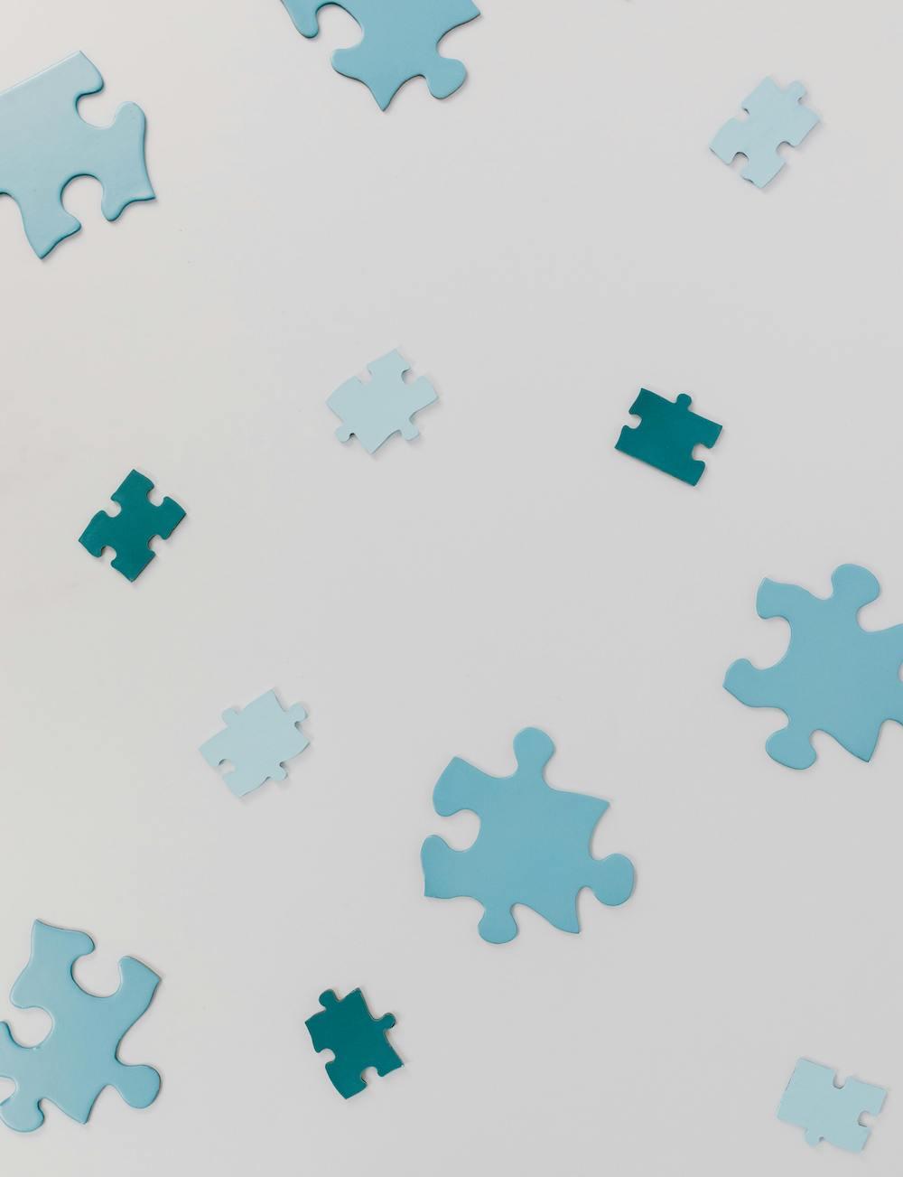 Disconnected puzzle pieces on a white background