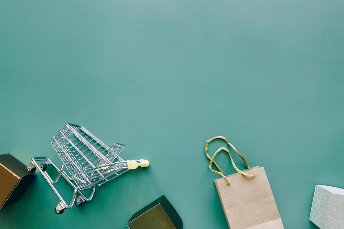 Checkout cart and bags on a teal background