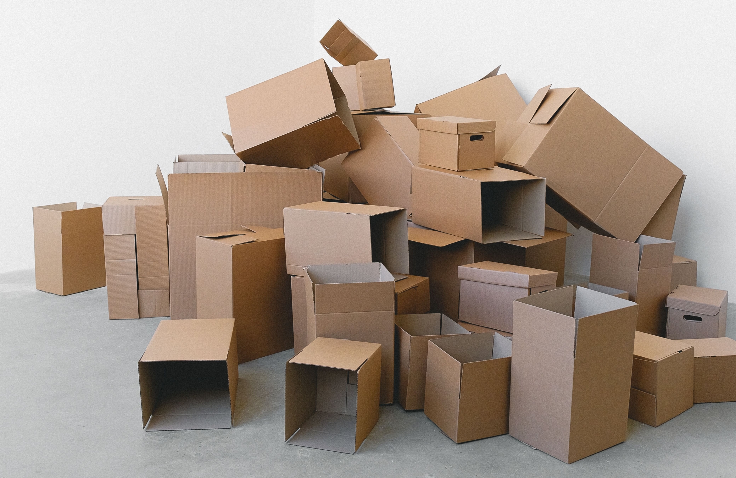 Empty boxes piled up in the corner of a room