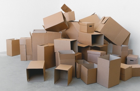 Empty boxes piled up in the corner of a room