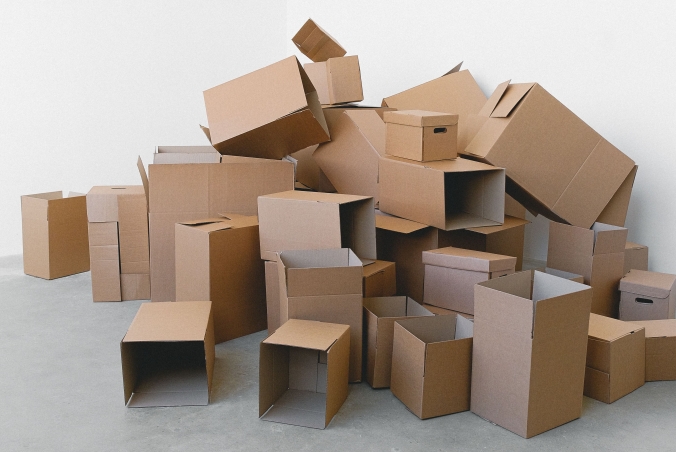 Empty boxes piled up in the corner of a room